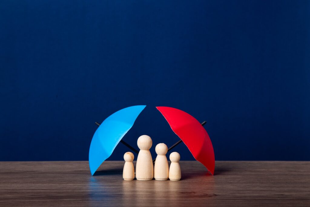 Umbrella and wooden doll figures.